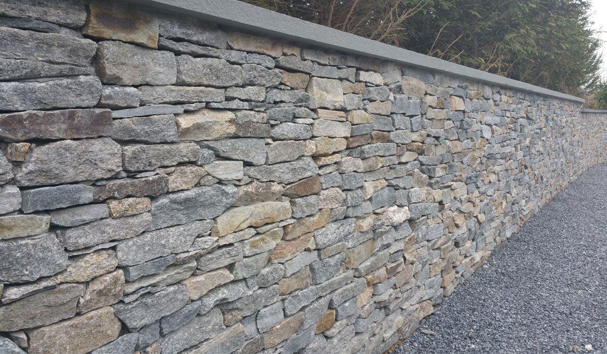 Stone Faced Retaining wall with Bluestone Caps by Hamptons Masonry Design